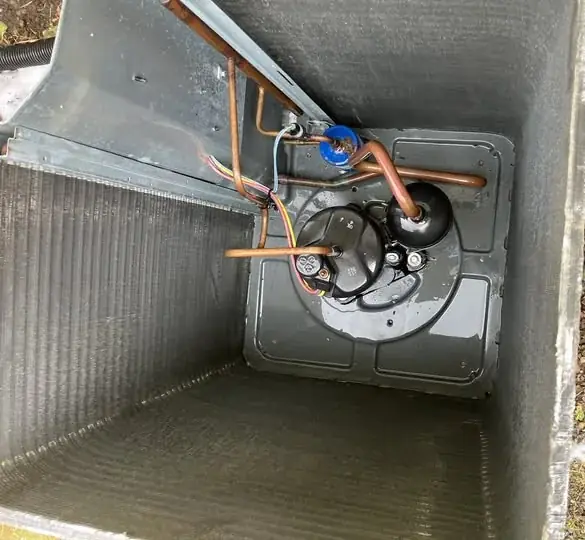 Cleaner interior of the paired opened AC unit after maintenance