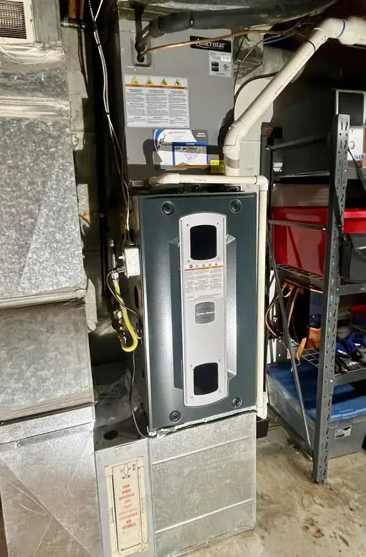 American Standard furnace connected to ductwork in a mechanical room