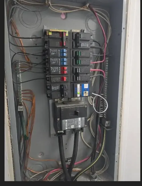 Open electrical panel with breakers, wiring and a mounted surge-protection device