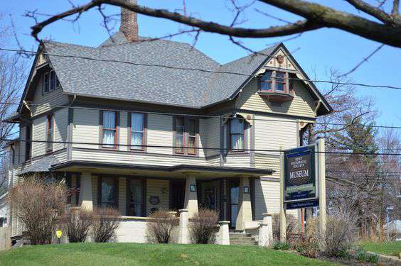 Historic Kent Historical Museum building with a prominent sign, surrounded by greenery and trees, showcasing local heritage in Kent, WA.