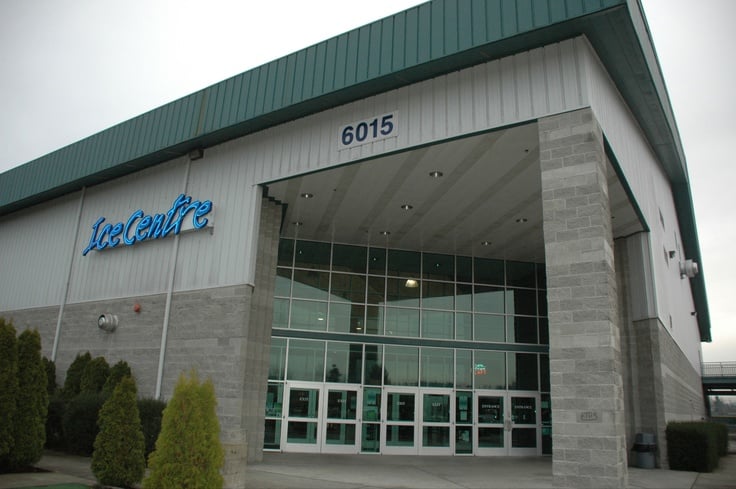 Ice Centre building exterior with glass doors and green roof. Consider Heat Pump Installation for your building in Seattle, WA.