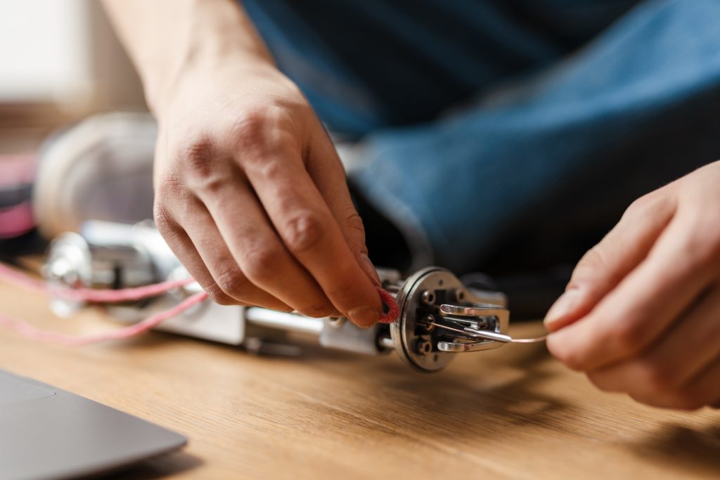 young-white-man-working-with-sewing-machine-indoor-2025-02-15-03-49-38-utc | Breeze Heating Air & Electrical Heating, AC & Electrical