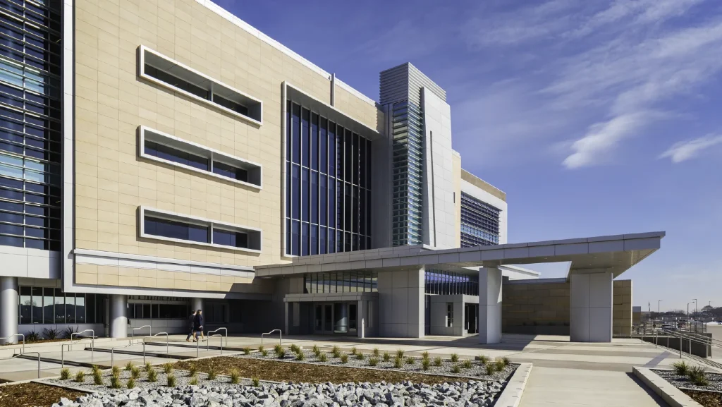 Modern building with glass and stone facade, showcasing electrical design and architectural lighting in Seattle, WA. Commercial architecture view.