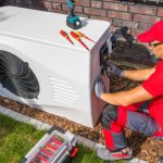 Heat pump installation in Kent, WA. Technician working on a modern heat pump system with tools on top, ensuring efficient home heating solutions.